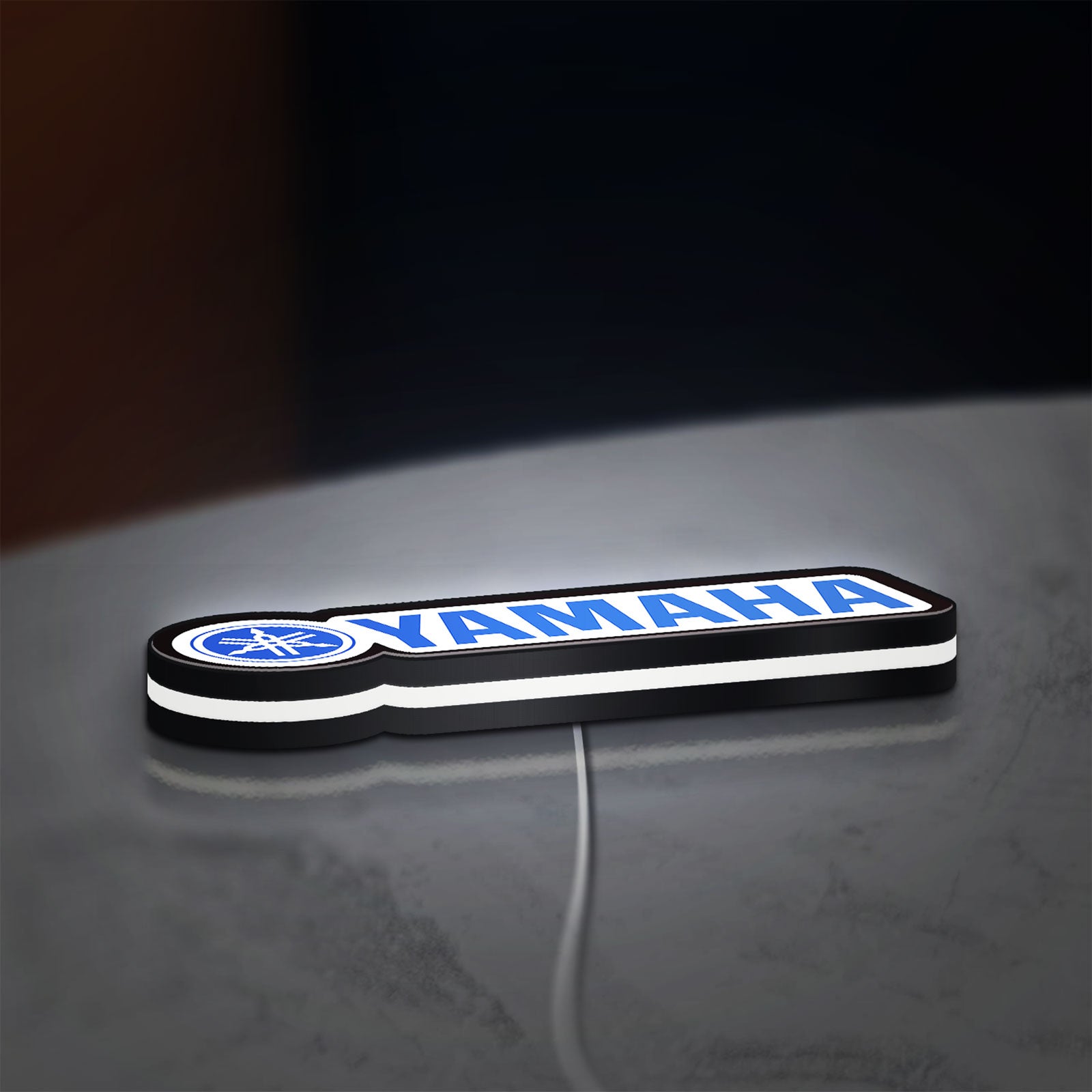 Yamaha LED lightbox lying flat on a desk with white glow