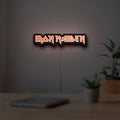 Iron Maiden LED lightbox hanging on a room wall with soft white light