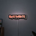 Iron Maiden LED lightbox hanging on a wall with white glow