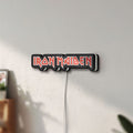 Unlit Iron Maiden LED lightbox mounted on a wall in daylight