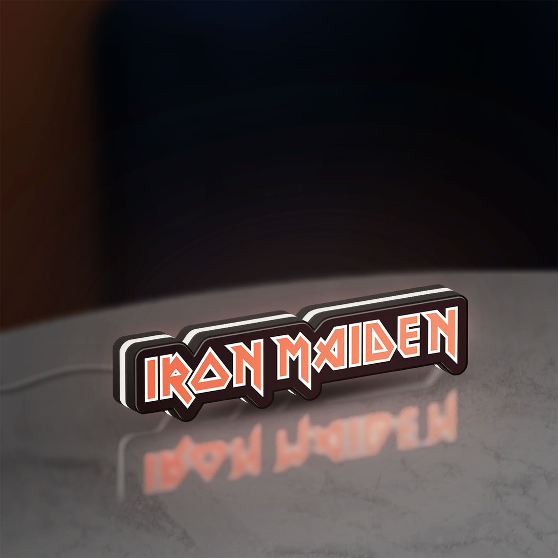 Iron Maiden LED lightbox hanging on a wall with white glow