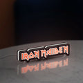Iron Maiden LED lightbox standing on a desk from an angled side view with white glow