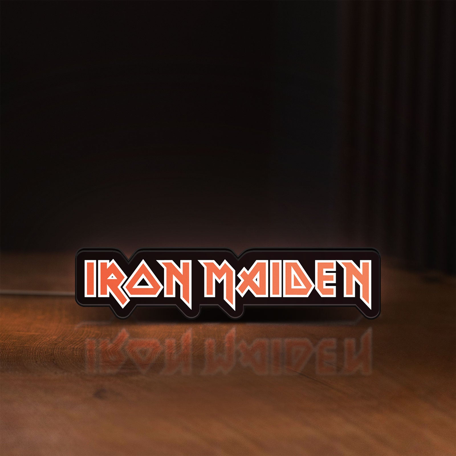 Front view of Iron Maiden LED lightbox sign glowing on a wooden desk