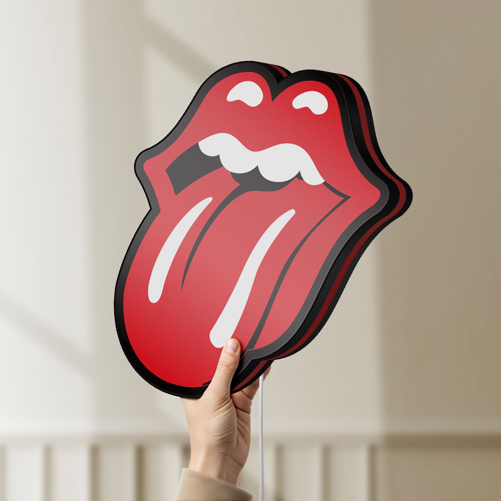 Unlit Rolling Stones LED lightbox held by hand to show size and details