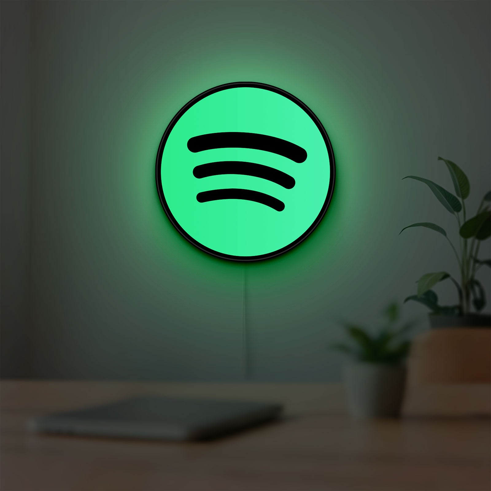 Spotify 2015 LED lightbox hanging on a room wall with soft green light
