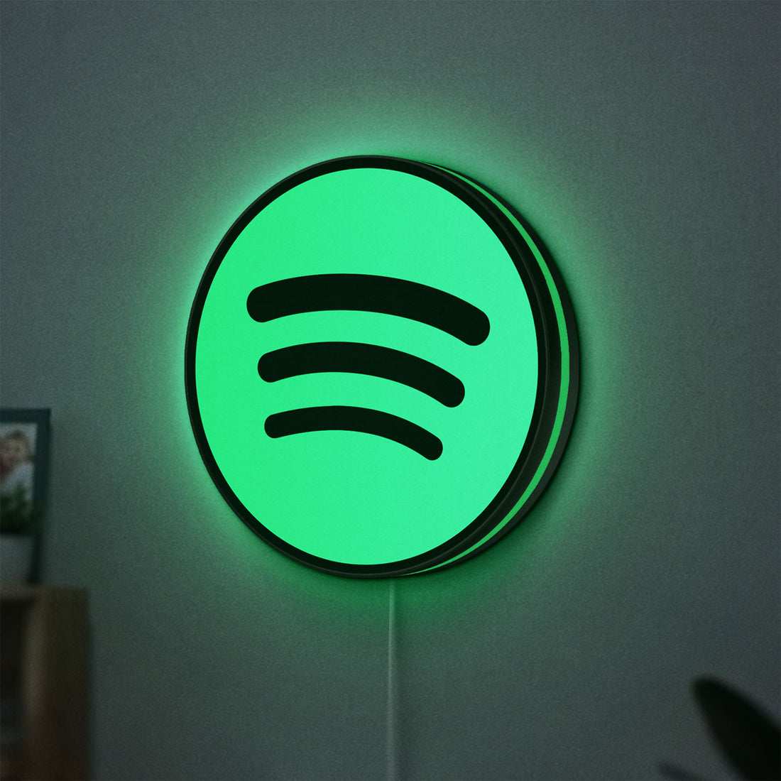 Spotify 2015 LED lightbox hanging on a wall with green glow