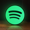 Front view of Spotify 2015 LED lightbox sign glowing on a wooden desk