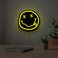 Nirvana LED lightbox hanging on a room wall with soft yellow light