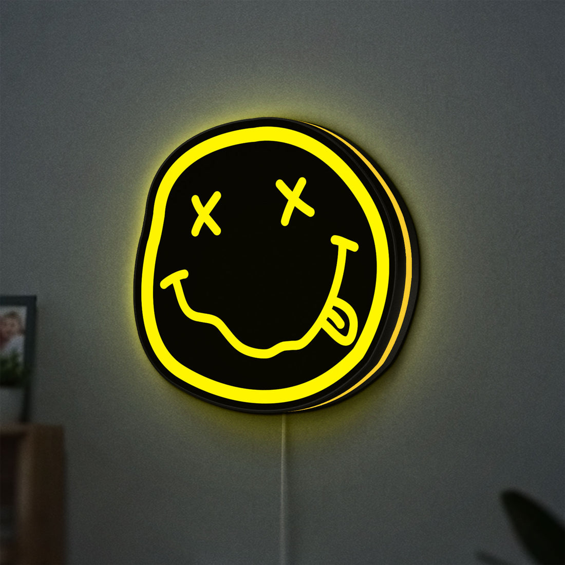 Nirvana LED lightbox hanging on a wall with yellow glow