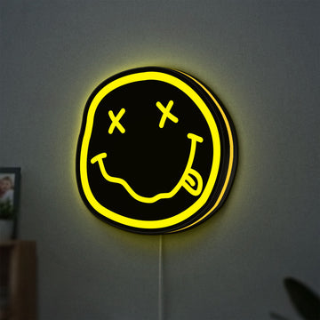 Nirvana LED lightbox hanging on a wall with yellow glow