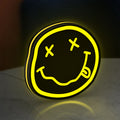 Nirvana LED lightbox standing on a desk from an angled side view with yellow glow