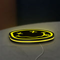Nirvana LED lightbox lying flat on a desk with yellow glow