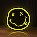 Front view of Nirvana LED lightbox sign glowing on a wooden desk