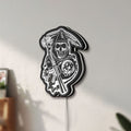 Unlit Sons of Anarchy LED lightbox mounted on a wall in daylight