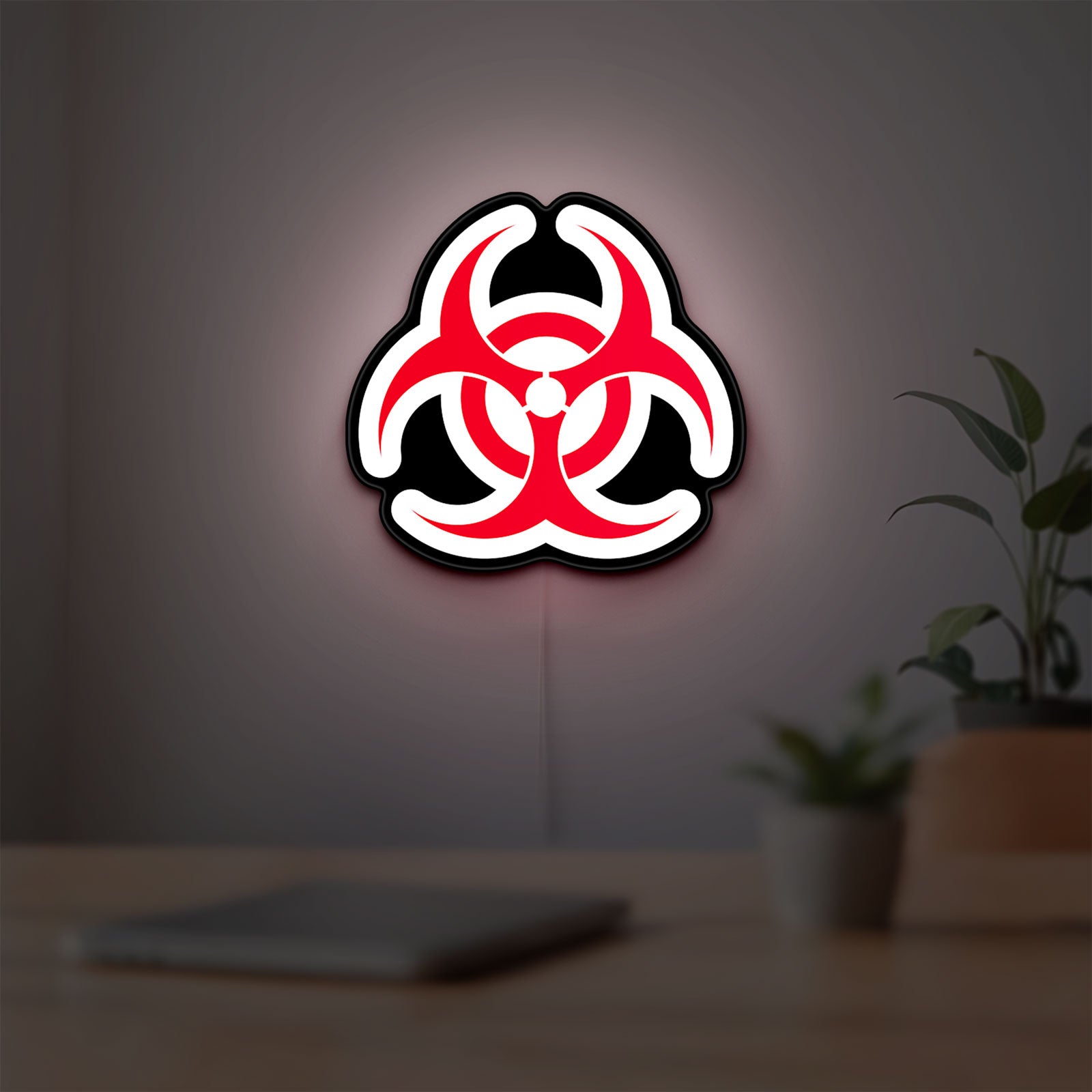 Biohazard LED lightbox hanging on a room wall with soft white light
