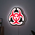Biohazard LED lightbox hanging on a wall with white glow