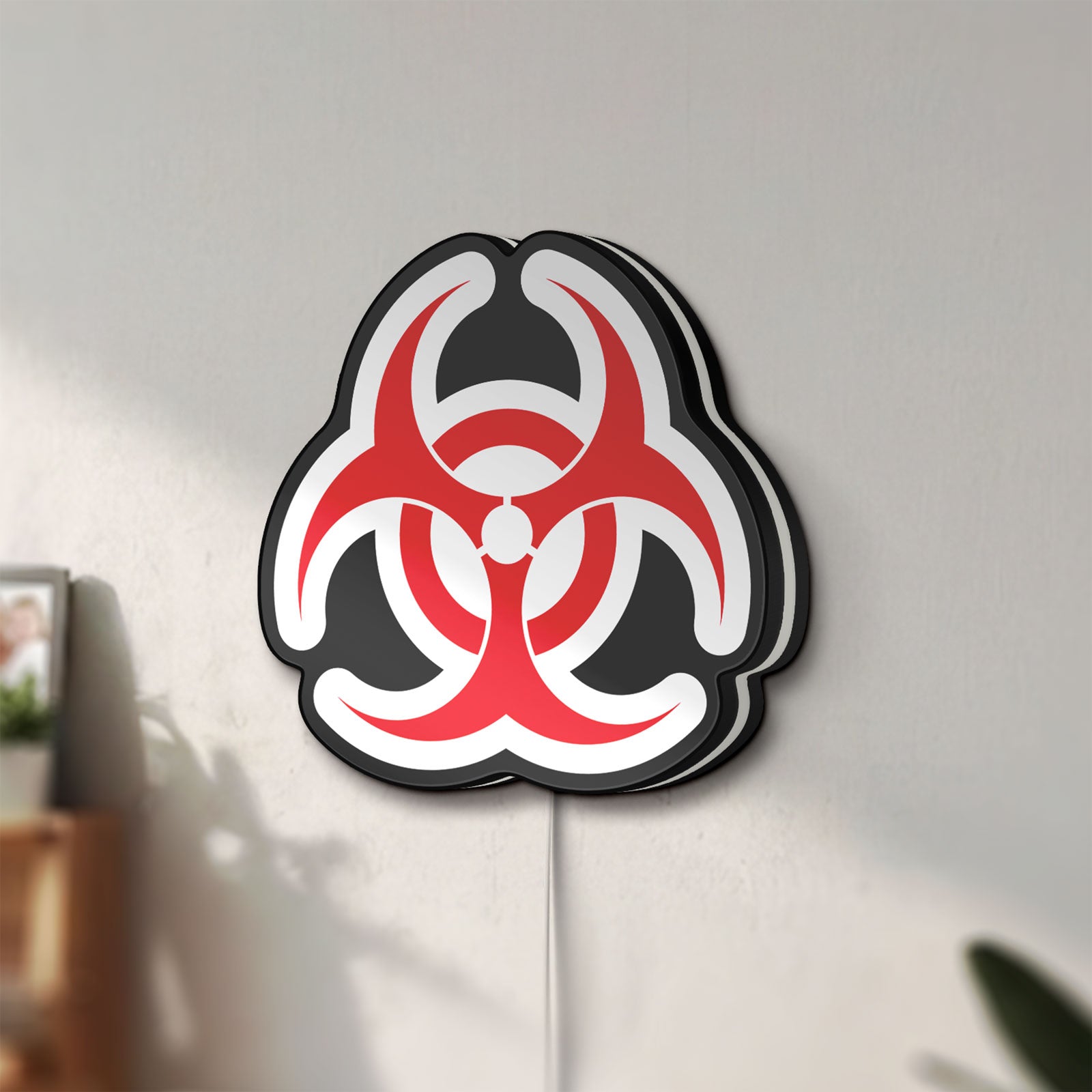 Unlit Biohazard LED lightbox mounted on a wall in daylight