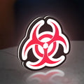 Biohazard LED lightbox standing on a desk from an angled side view with white glow