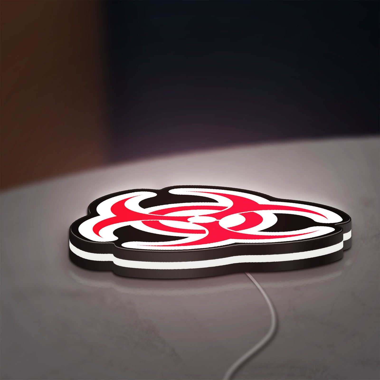 Biohazard LED lightbox lying flat on a desk with white glow