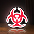 Front view of Biohazard LED lightbox sign glowing on a wooden desk