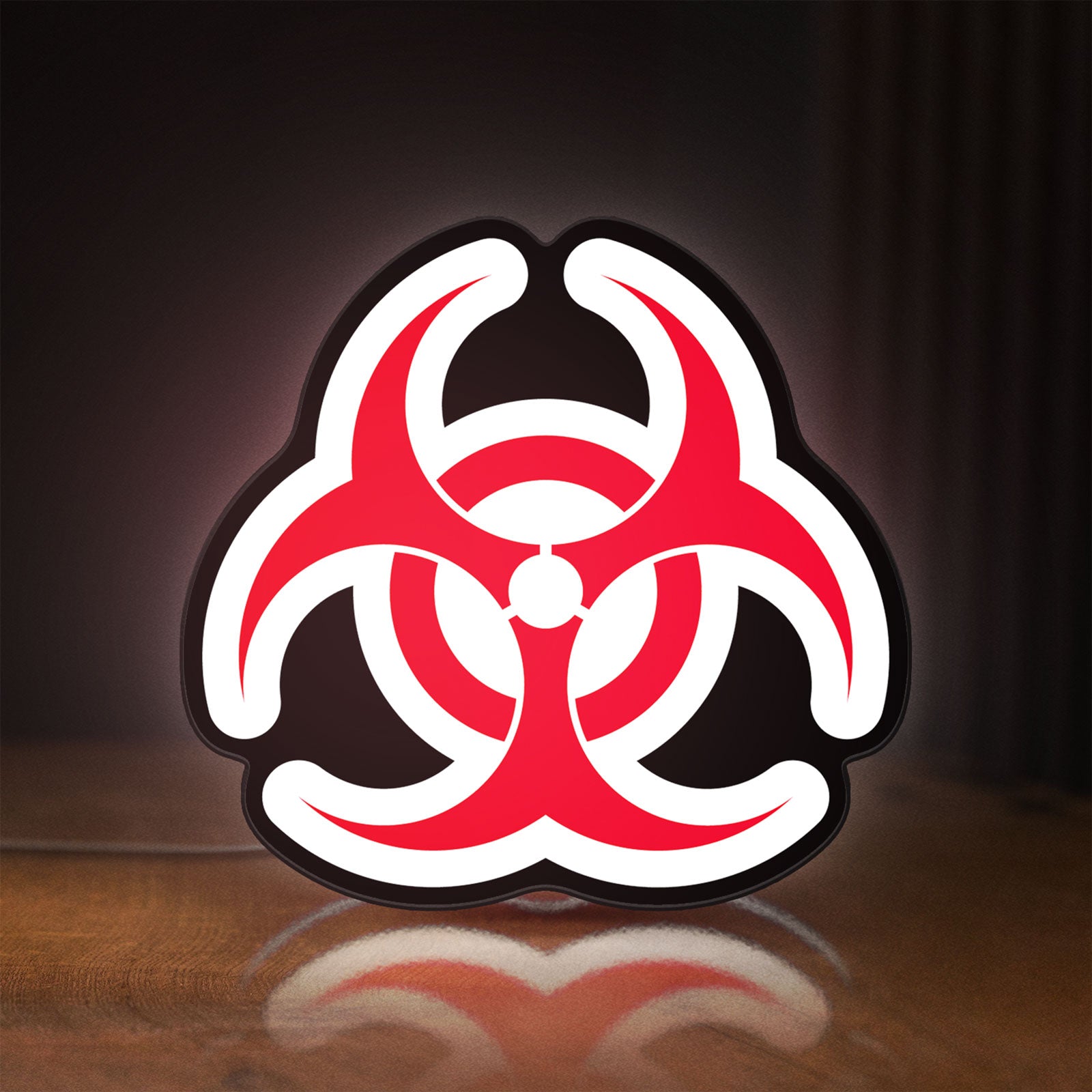 Front view of Biohazard LED lightbox sign glowing on a wooden desk