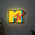 MTV Music Television LED lightbox hanging on a wall with yellow glow