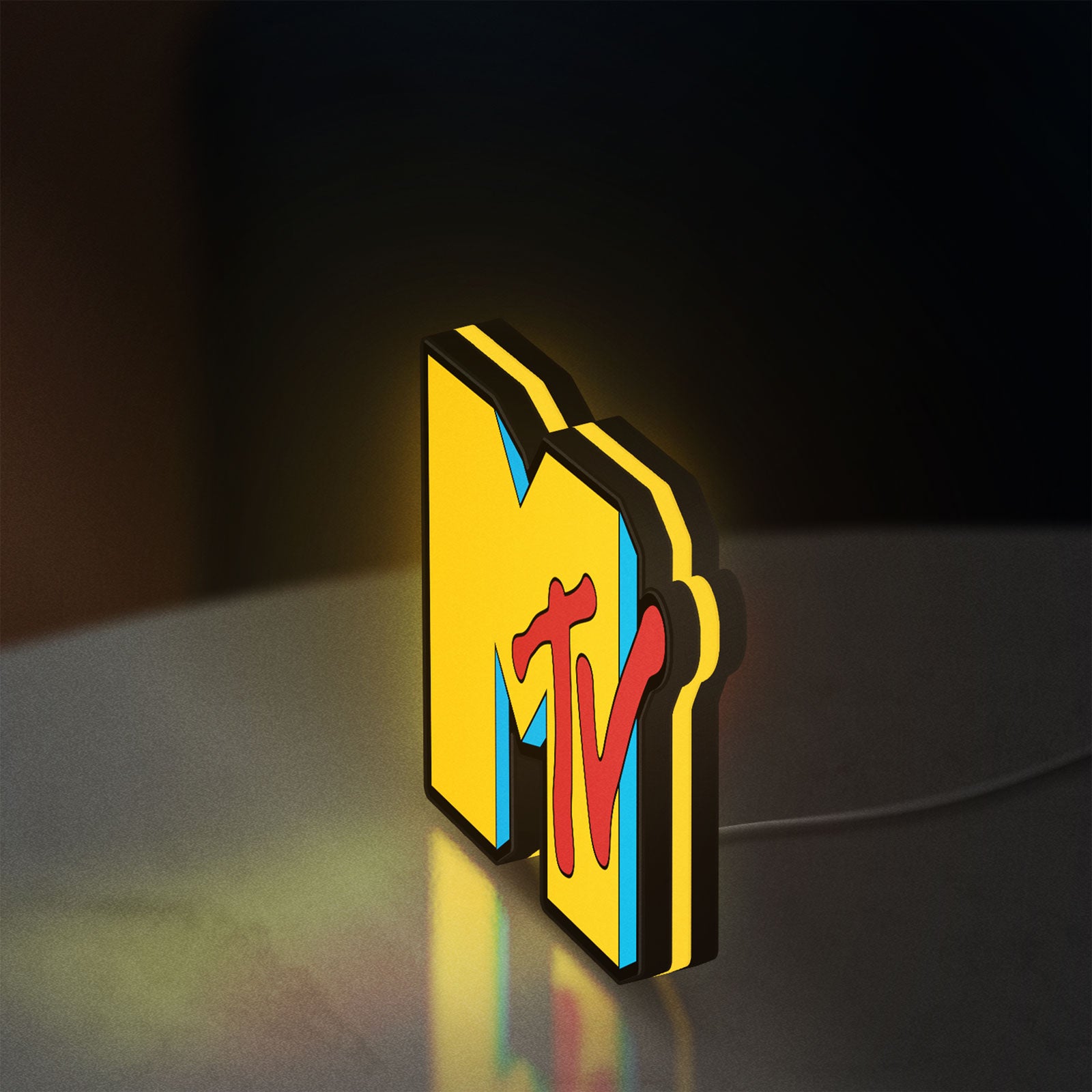 MTV Music Television LED lightbox glowing on a desk with yellow glow