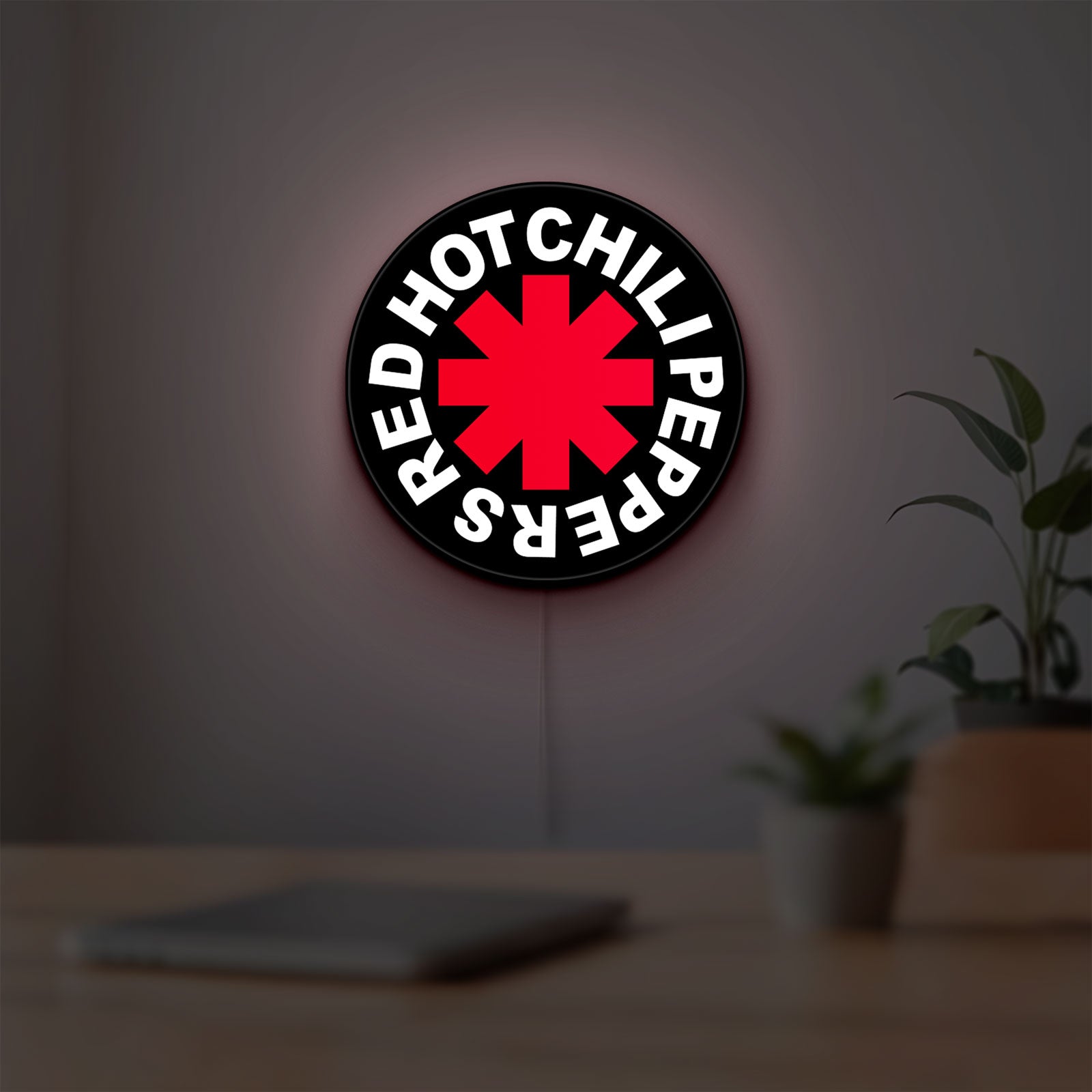Red Hot Chili Peppers LED lightbox hanging on a room wall with soft white light