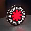 Red Hot Chili Peppers LED lightbox standing on a desk from an angled side view with white glow