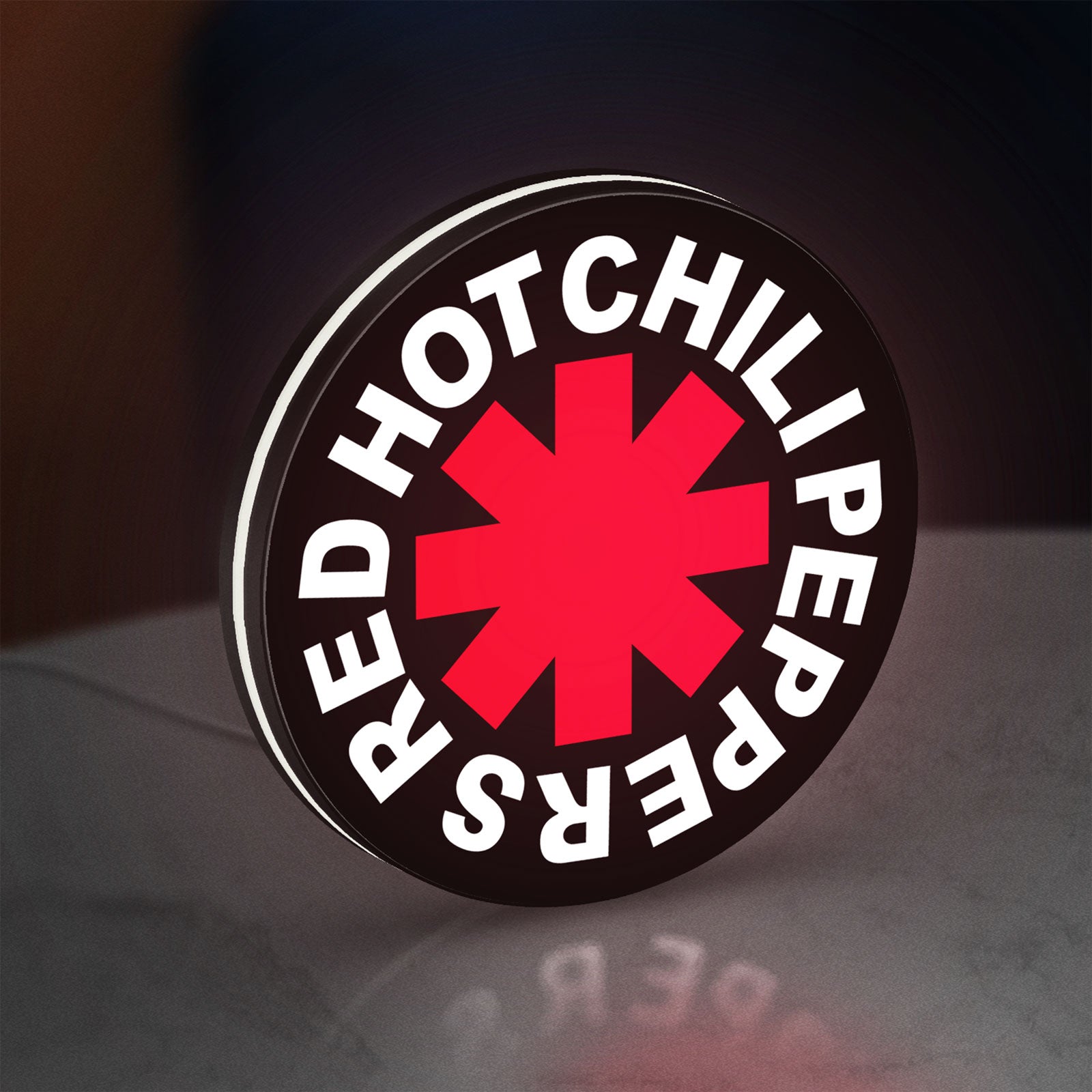 Red Hot Chili Peppers LED lightbox standing on a desk from an angled side view with white glow