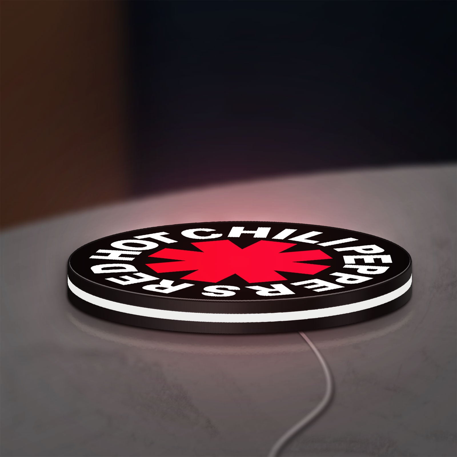 Red Hot Chili Peppers LED lightbox lying flat on a desk with white glow