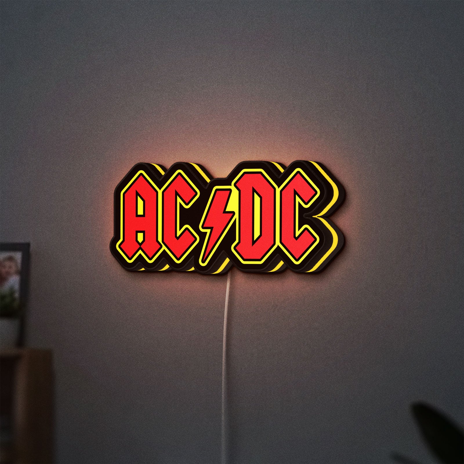 AC DC Red LED lightbox hanging on a wall with yellow glow