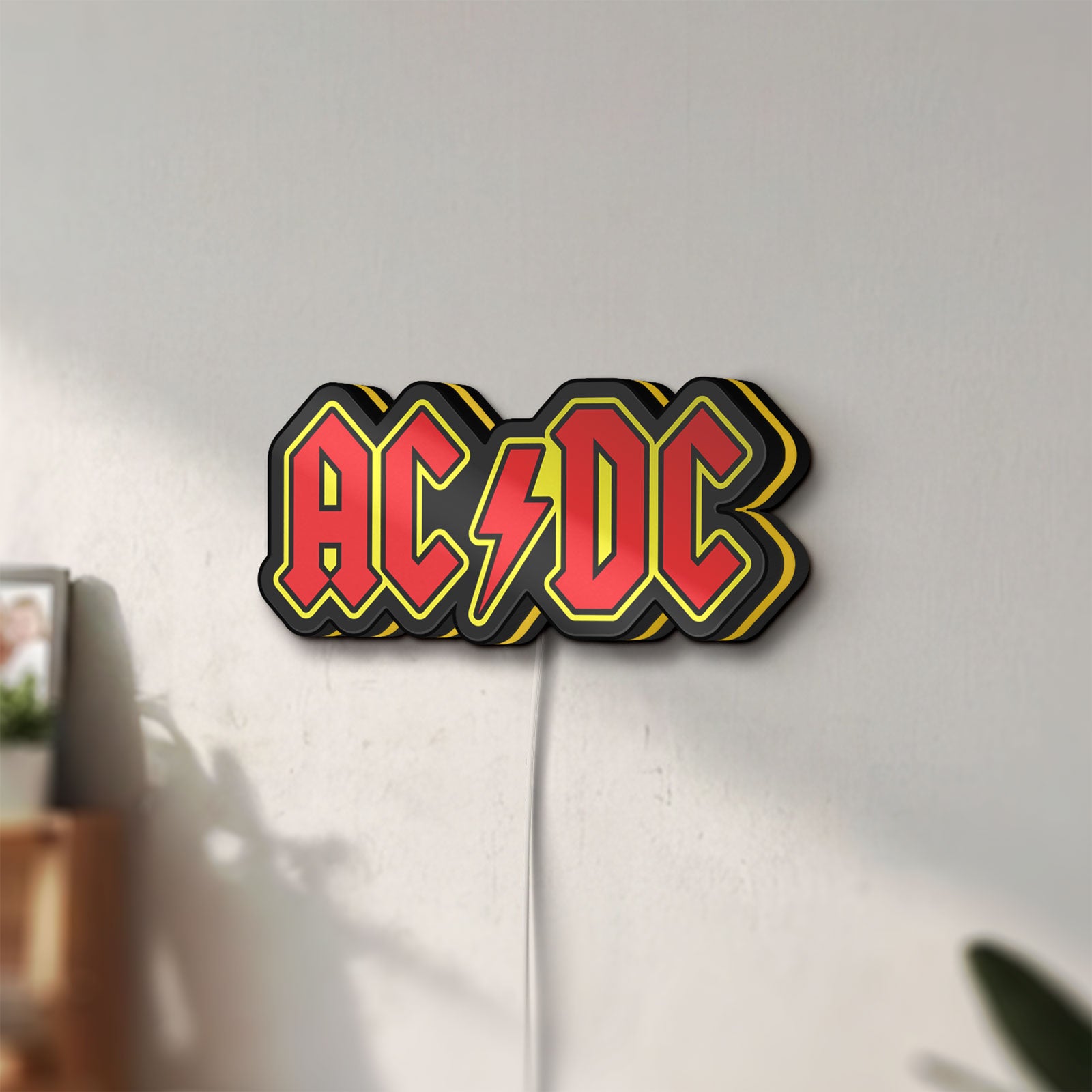 Unlit AC DC Red LED lightbox mounted on a wall in daylight