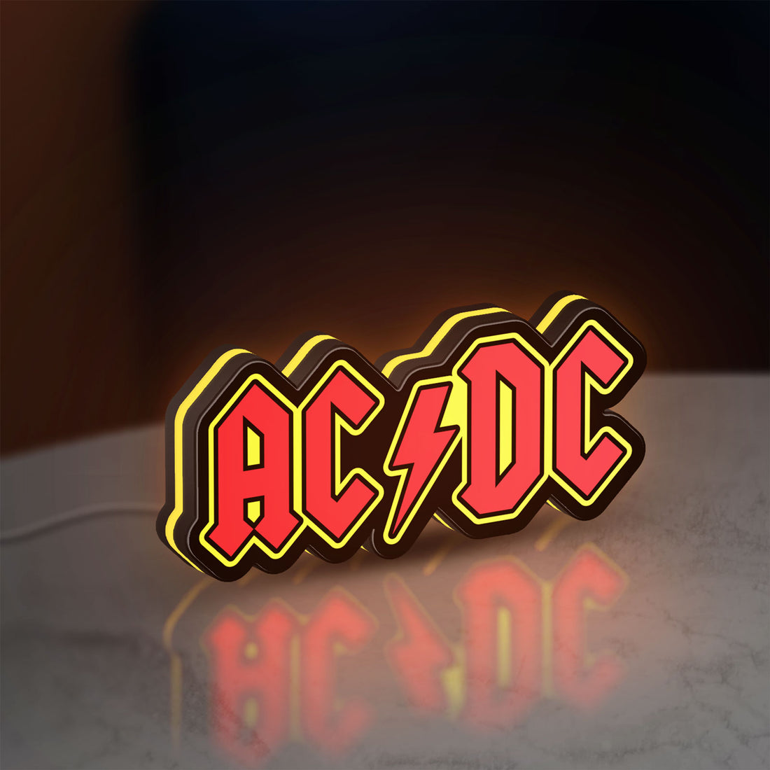 AC DC Red LED lightbox hanging on a wall with yellow glow