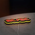AC DC Red LED lightbox lying flat on a desk with yellow glow
