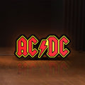 Front view of AC DC Red LED lightbox sign glowing on a wooden desk