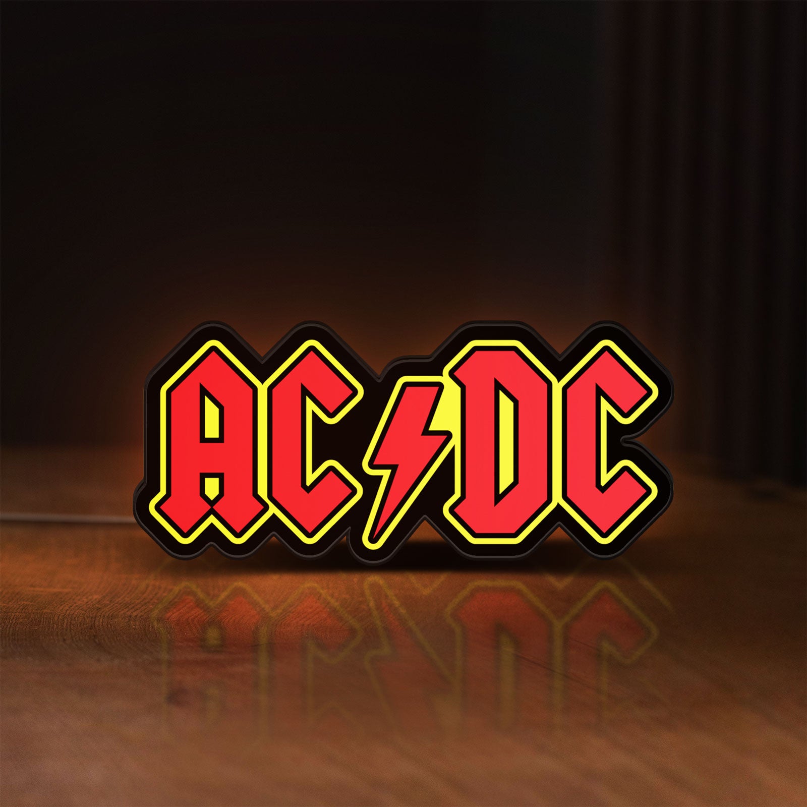 Front view of AC DC Red LED lightbox sign glowing on a wooden desk