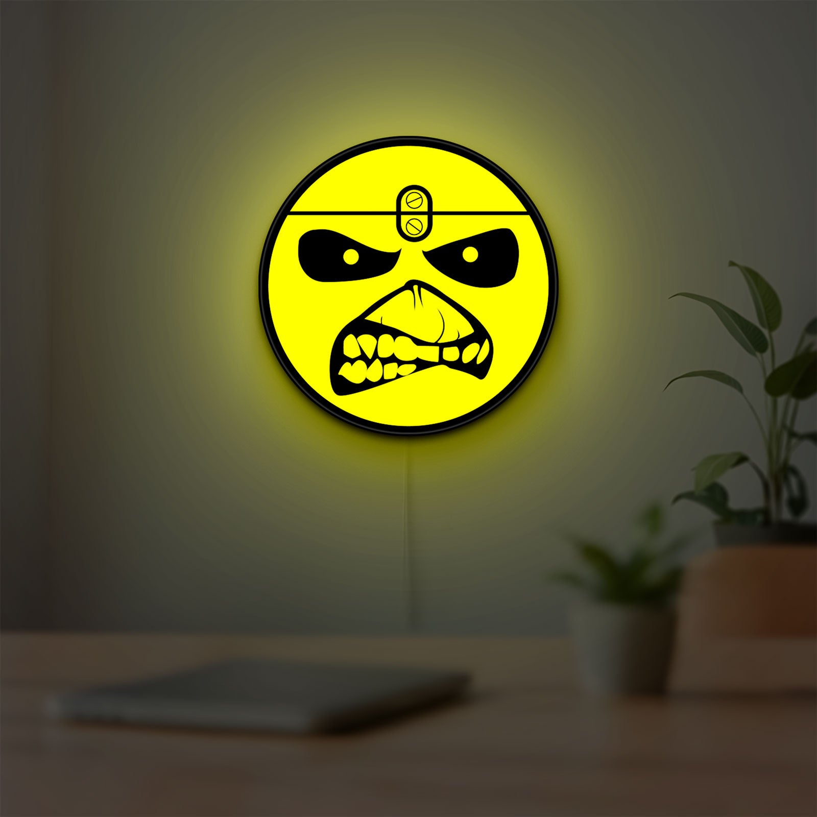 Iron Maiden Eddie LED lightbox hanging on a room wall with soft yellow light
