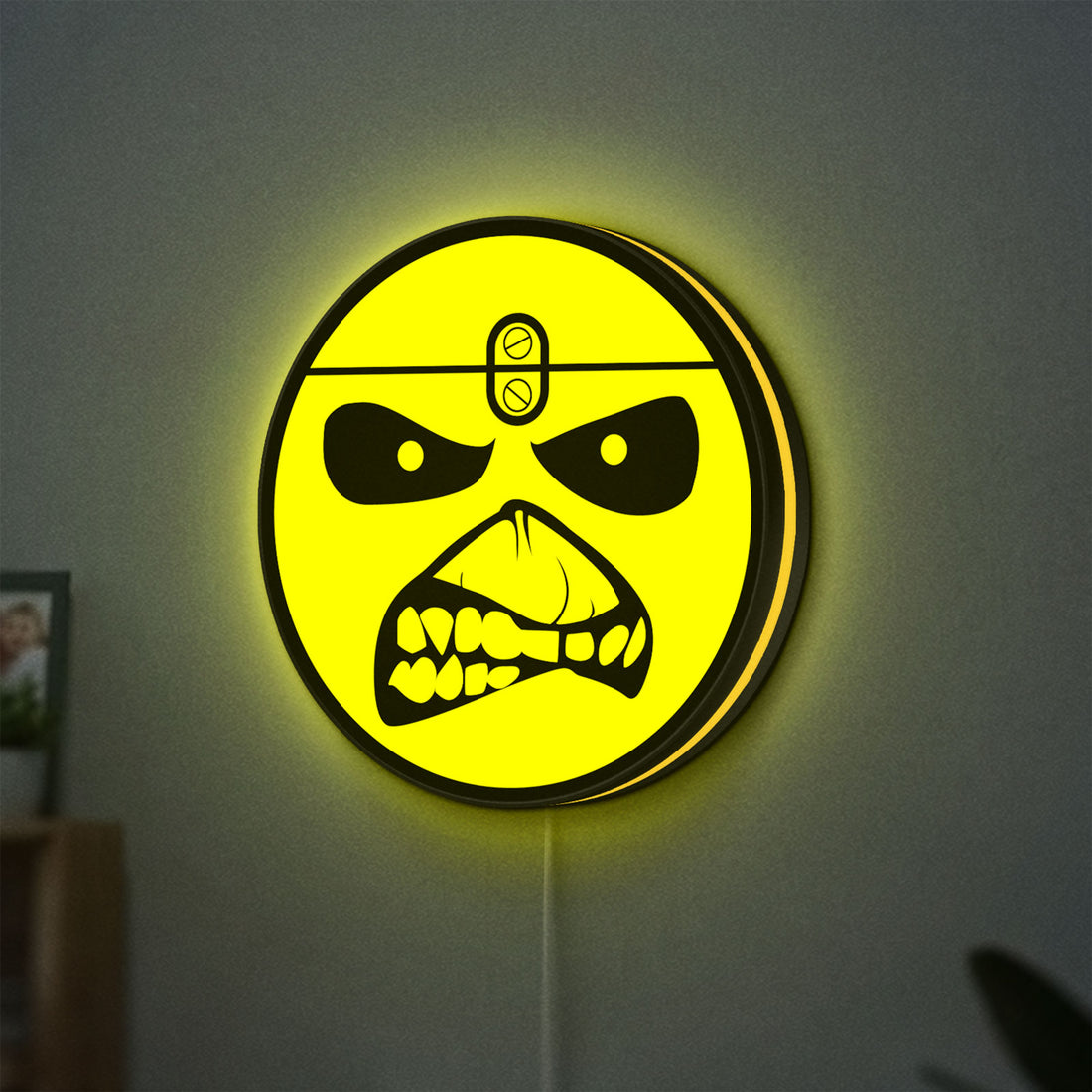 Iron Maiden Eddie LED lightbox hanging on a wall with yellow glow