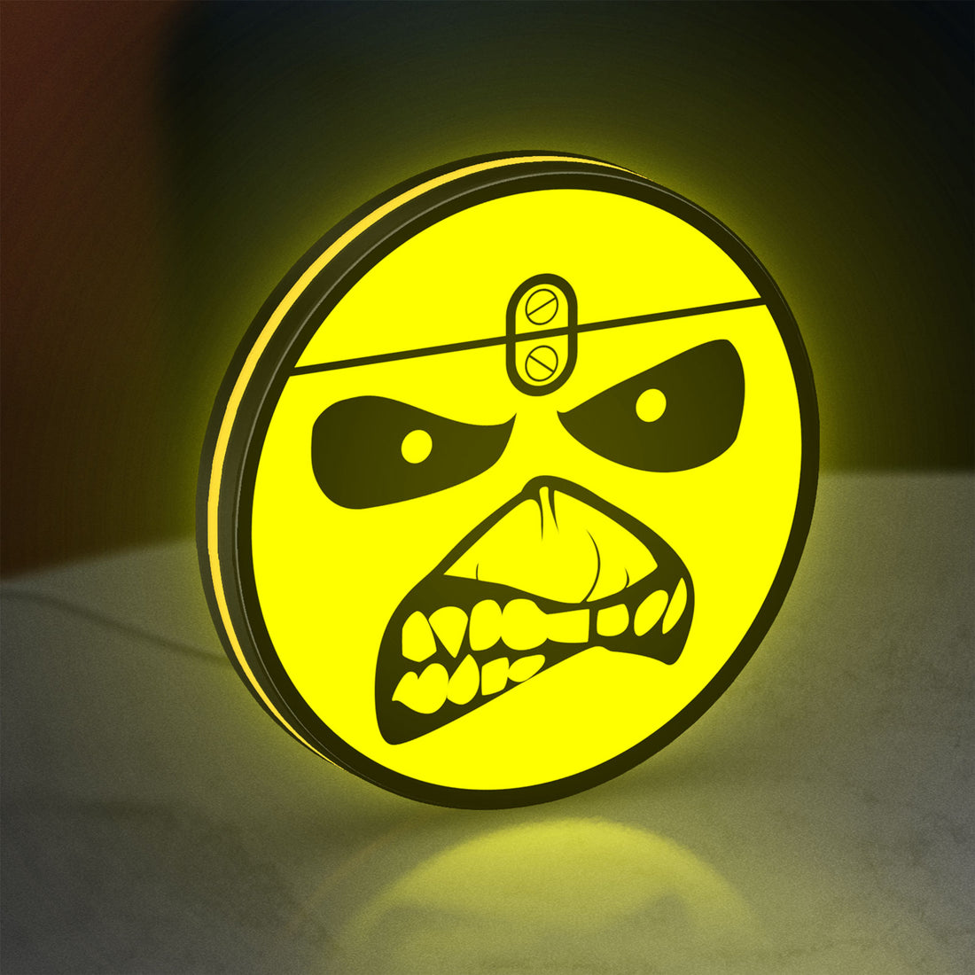 Iron Maiden Eddie LED lightbox hanging on a wall with yellow glow