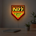 Kiss Army LED lightbox hanging on a room wall with soft yellow light