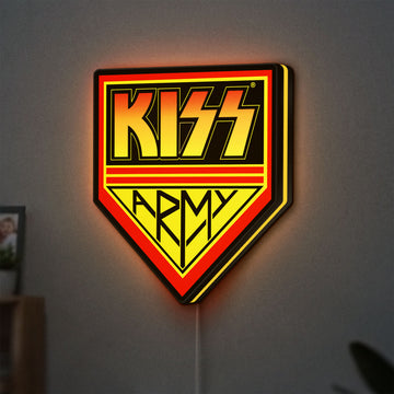 Kiss Army LED lightbox hanging on a wall with yellow glow