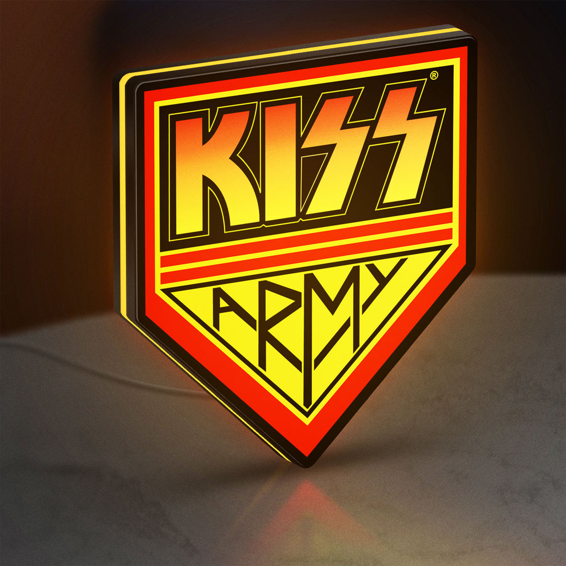 Kiss Army LED lightbox hanging on a wall with yellow glow