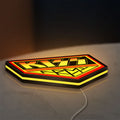 Kiss Army LED lightbox lying flat on a desk with yellow glow