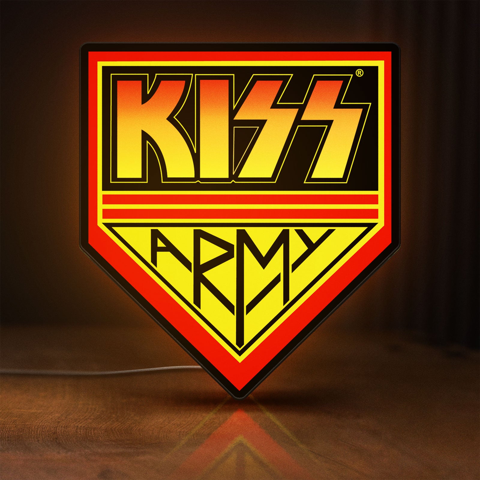 Front view of Kiss Army LED lightbox sign glowing on a wooden desk