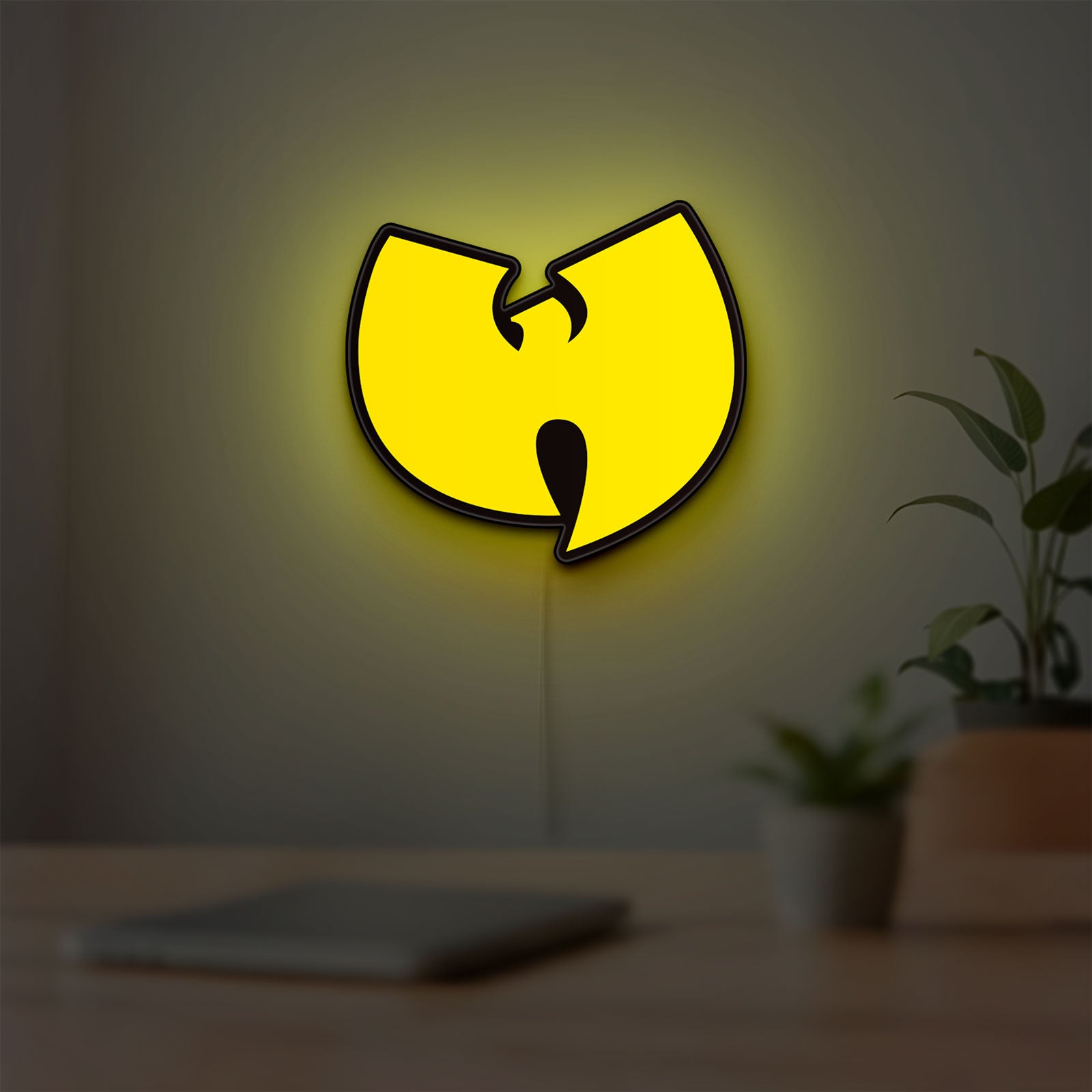Wu Tang LED lightbox hanging on a room wall with soft yellow light