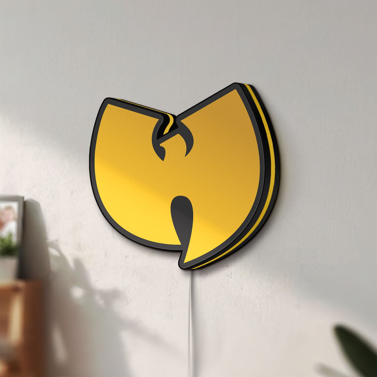 Unlit Wu Tang LED lightbox mounted on a wall in daylight