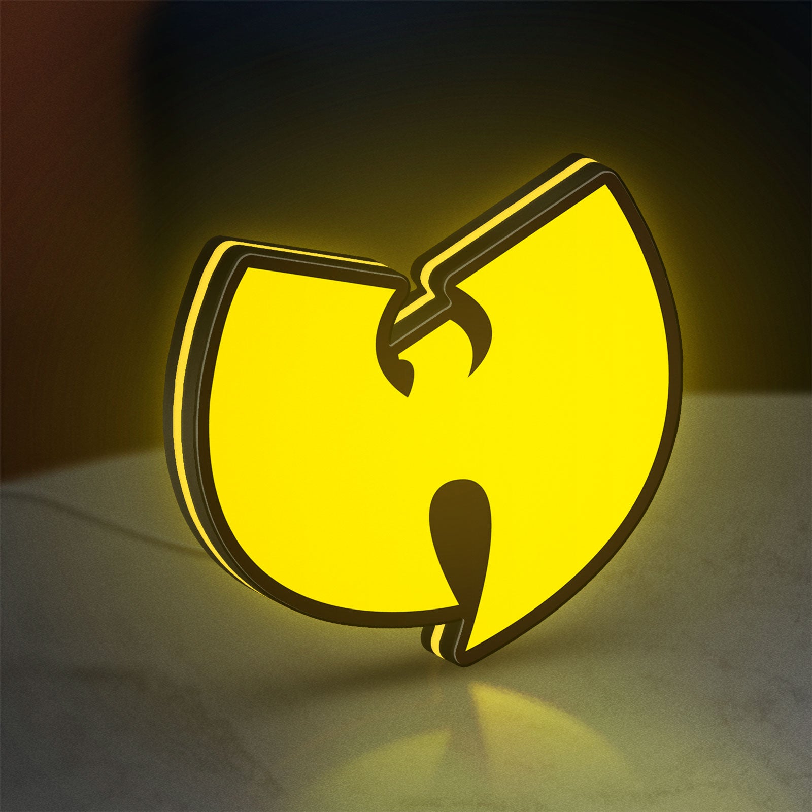 Wu Tang LED lightbox standing on a desk from an angled side view with yellow glow