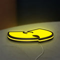 Wu Tang LED lightbox lying flat on a desk with yellow glow