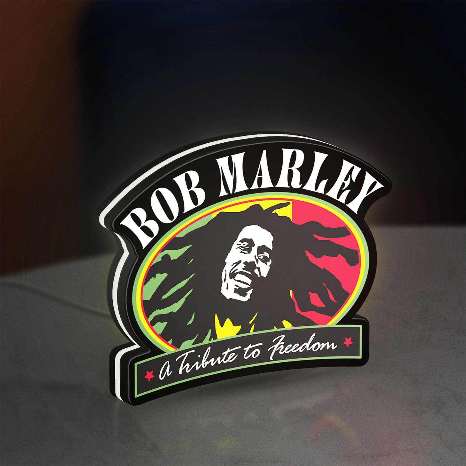 Bob Marley LED lightbox standing on a desk from an angled side view with white glow